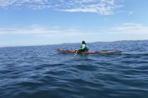 A kayaker far from land in the open ocean