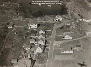 A vintage aerial photo of a military barracks by a rocky ocean cove