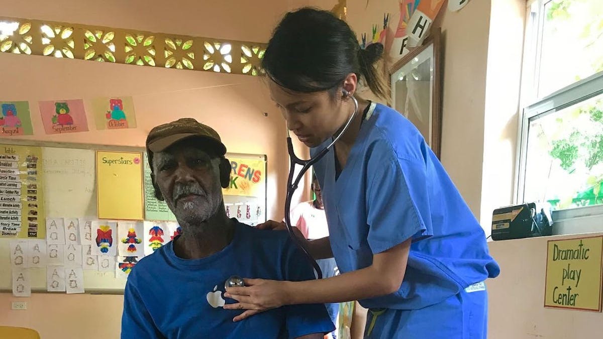 An elderly man having his blood pressure checked