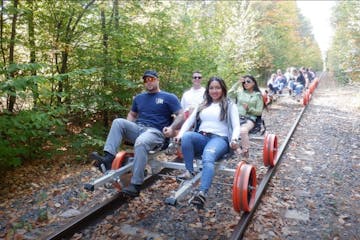 a group of people riding on a mountain train