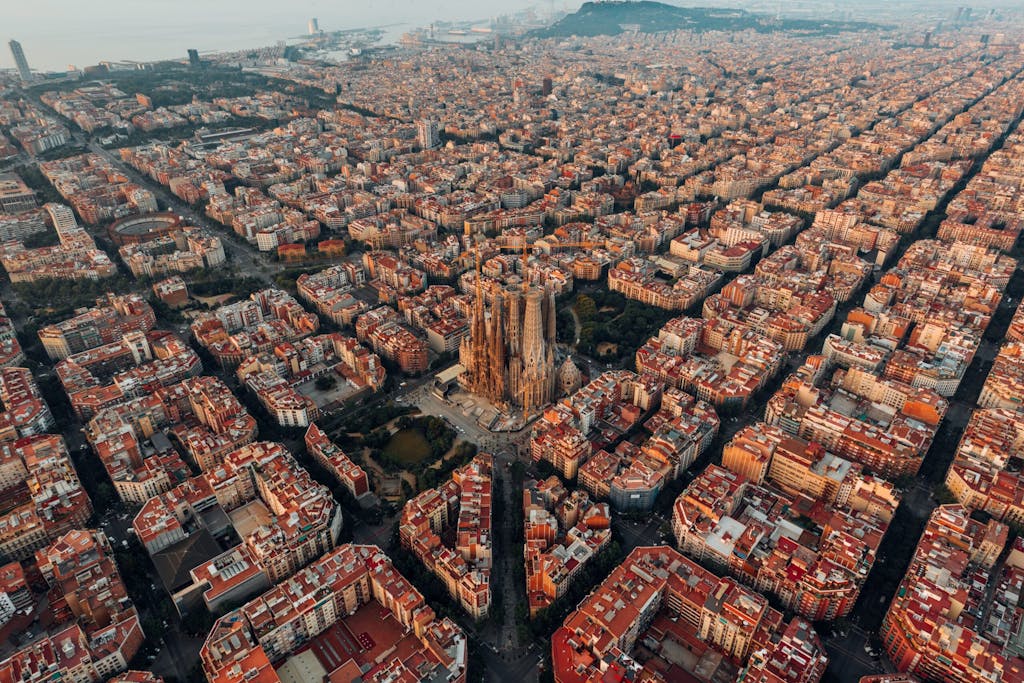 The city of Barcelona, overview of the brick buildings with many windows and the streets.