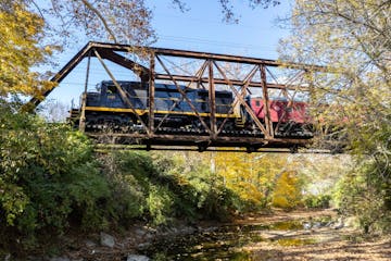a train crossing a bridge over a river