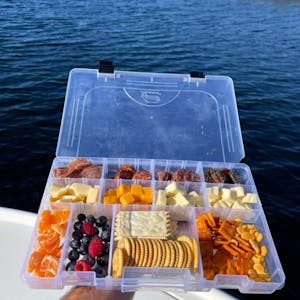 a tray with a hot dog on a boat in the water