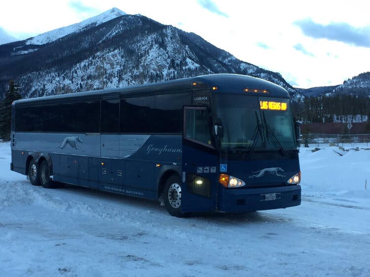 a bus parked on the side of a snow covered mountain