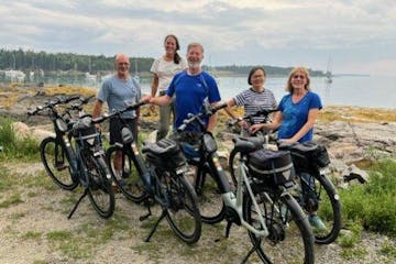 a group of people standing next to a bicycle