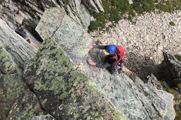 a person climbing up a rocky cliff