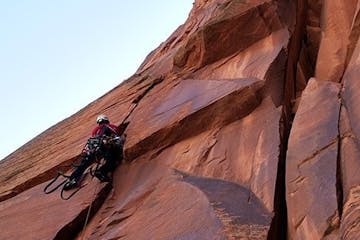 a person climbing up a rocky slope