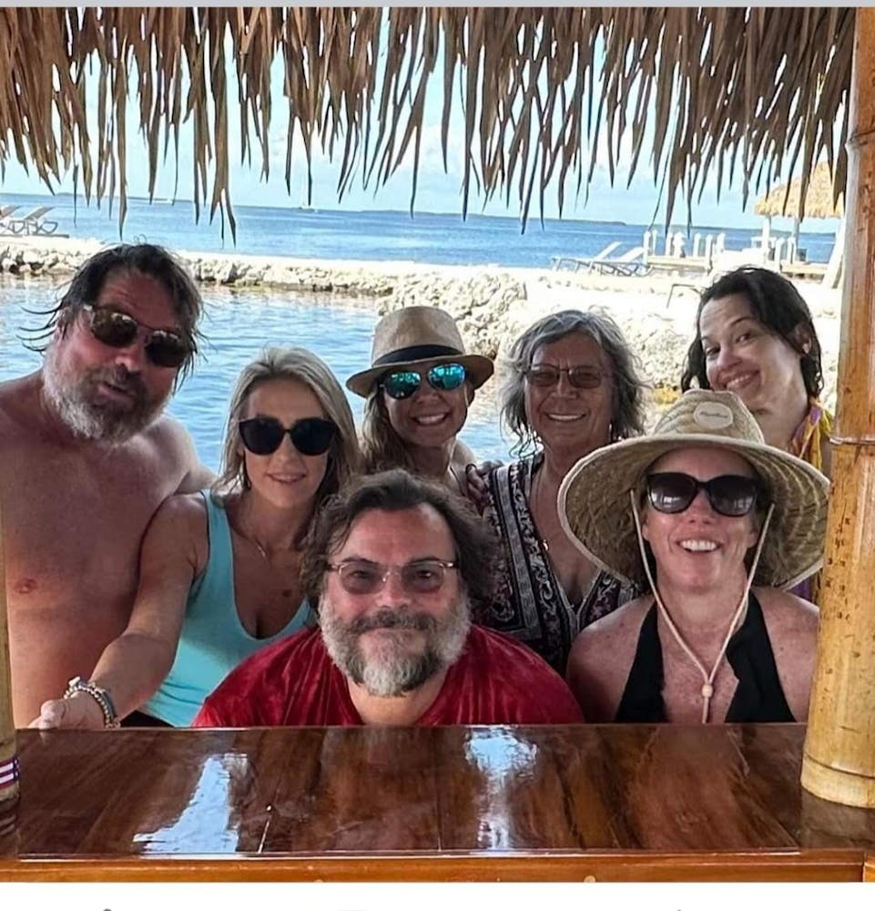 Jack Black et al. sitting next to a body of water