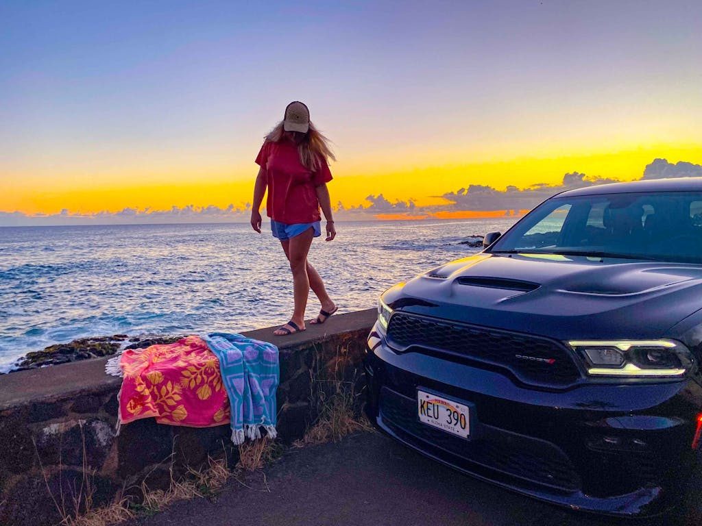 Elite kauai car rental parked by sea wall 