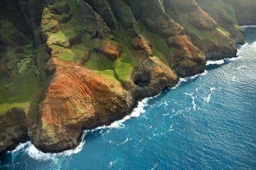 a large pool of water with Nā Pali Coast State Park in the background