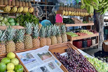 a variety of fruits and vegetables on display at a fruit stand