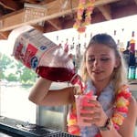 A girl pouring a drink in a cup