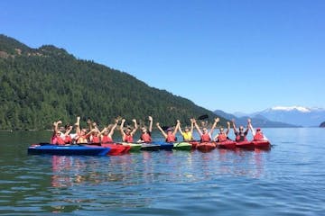 a group of people riding a kayak