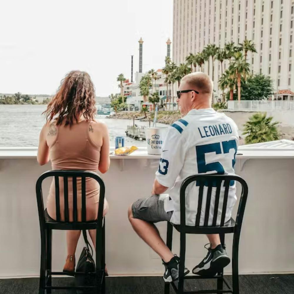 a couple sitting on chairs looking at view