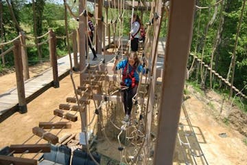a group of people in the ropes course of NevilleBillie Adventure Park