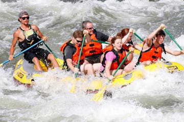 a group of people riding skis on a raft in a body of water