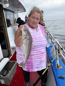 a person holding a fish on a boat
