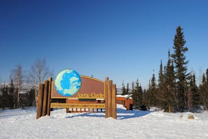 a sign on the side of a snow covered slope