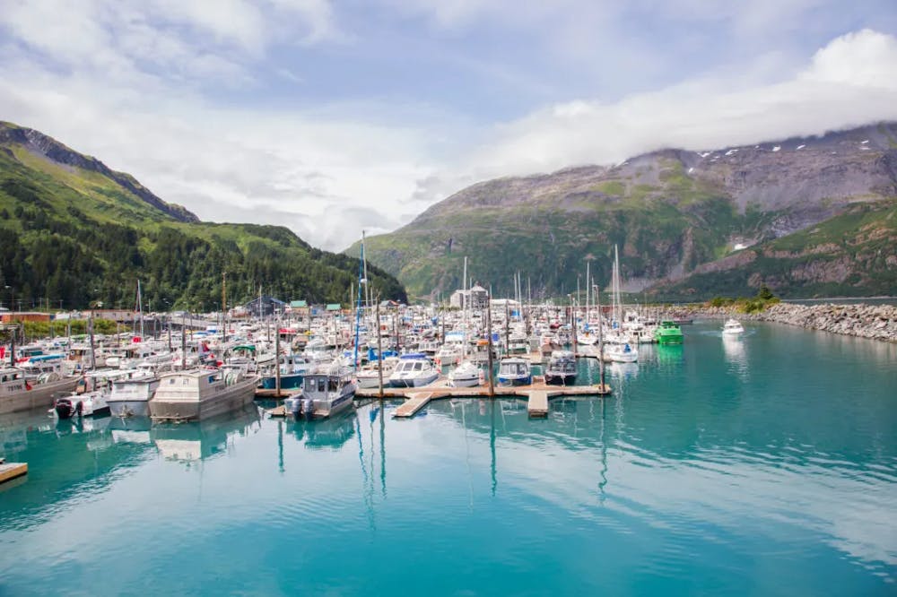 WHITTIER ALASKA/UNITED STATES – July 28: Boats are moored at the marina and are very protected in this harbor surrounded by mountains on 07/28/19 in Whittier AK.
