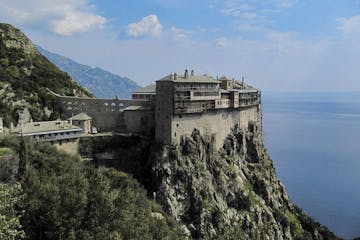 Mount Athos over a body of water with a mountain in the background