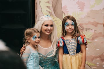 Three people dressed as princesses