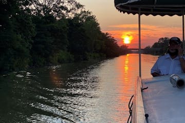a boat on a canal at sunset