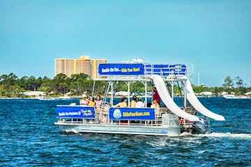 A group of people riding on a double decker pontoon boat