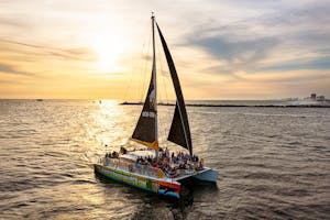 SV Privateer catamaran sailing in the Gulf of Mexico during sunset