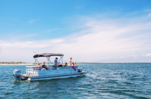 a group of people in the gulf of mexico on a pontoon boat