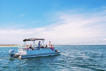 a group of people in the gulf of mexico on a pontoon boat