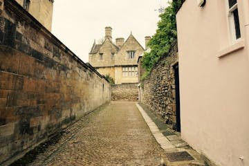 a walkway near an old stone building