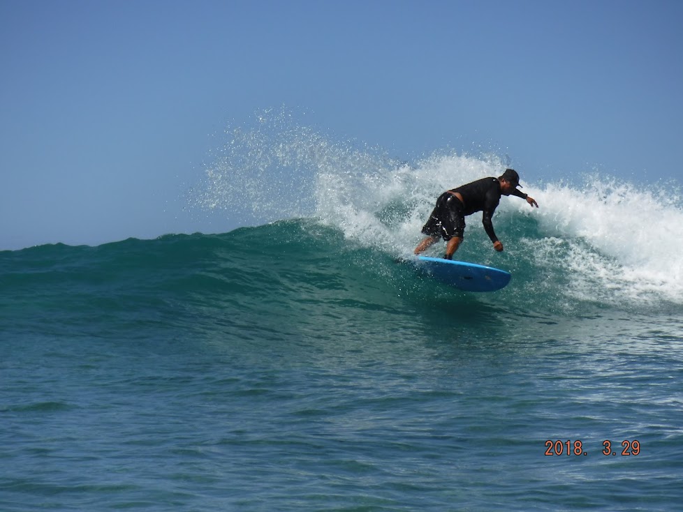 a man riding a wave on a surfboard in the water