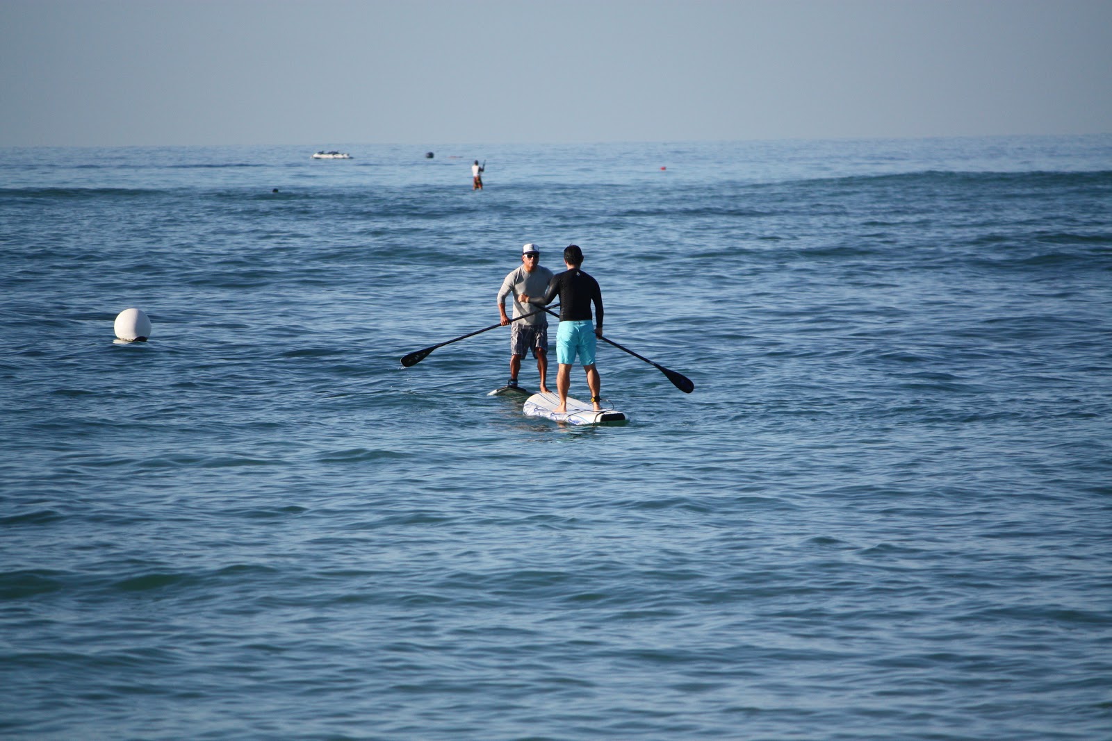 a man riding a paddle board on top of a body of water