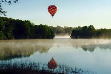Hot Air Balloon flying above a river