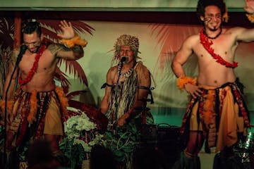Three men performing at a luau