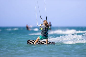 a person kiteboarding on a body of water