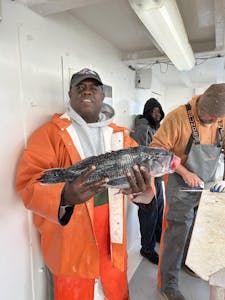 Rick Ross holding a fish