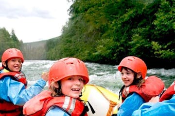 a family white water rafting in lake district, cumbria
