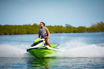 a man riding on the back of a jetski in a body of water