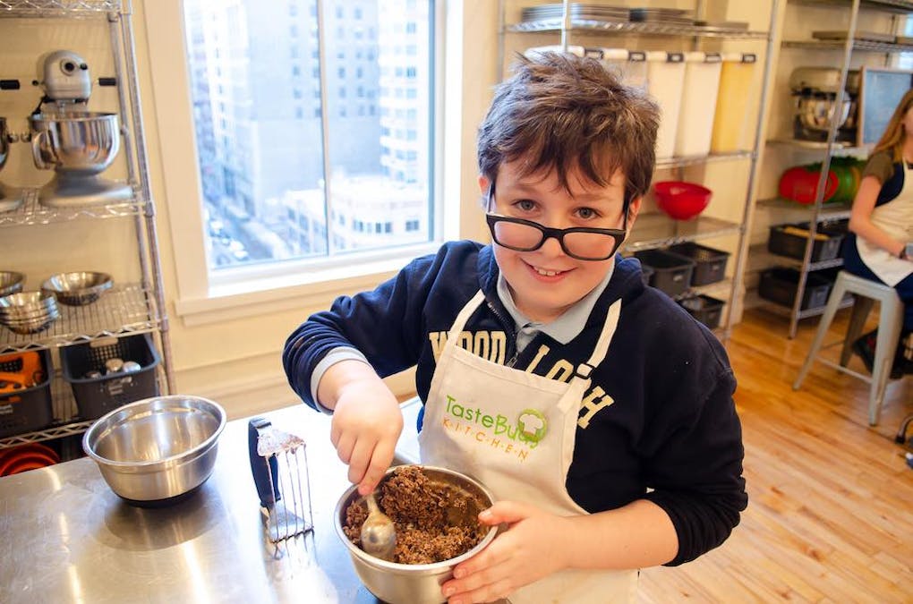 a boy with glasses mixing cookie dough