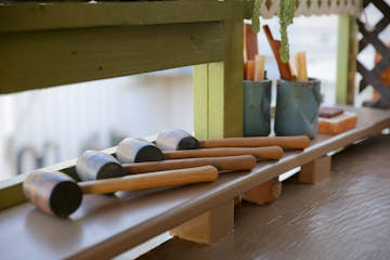 hammers placed on top of a wooden table