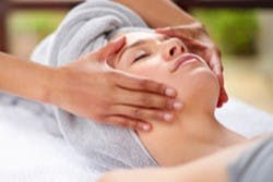 A woman receiving a massage at the spa. 