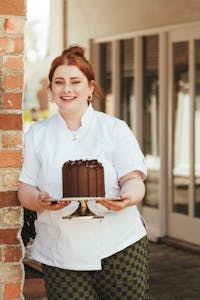 a person holding a cake