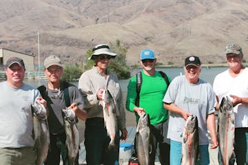 a group of men posing for the camera on a fishing trip