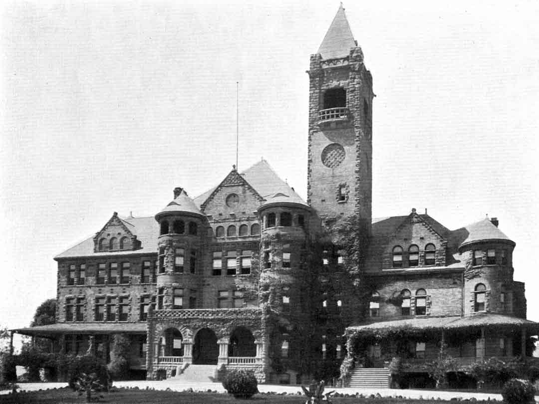 a vintage photo of a clock tower in front of a building