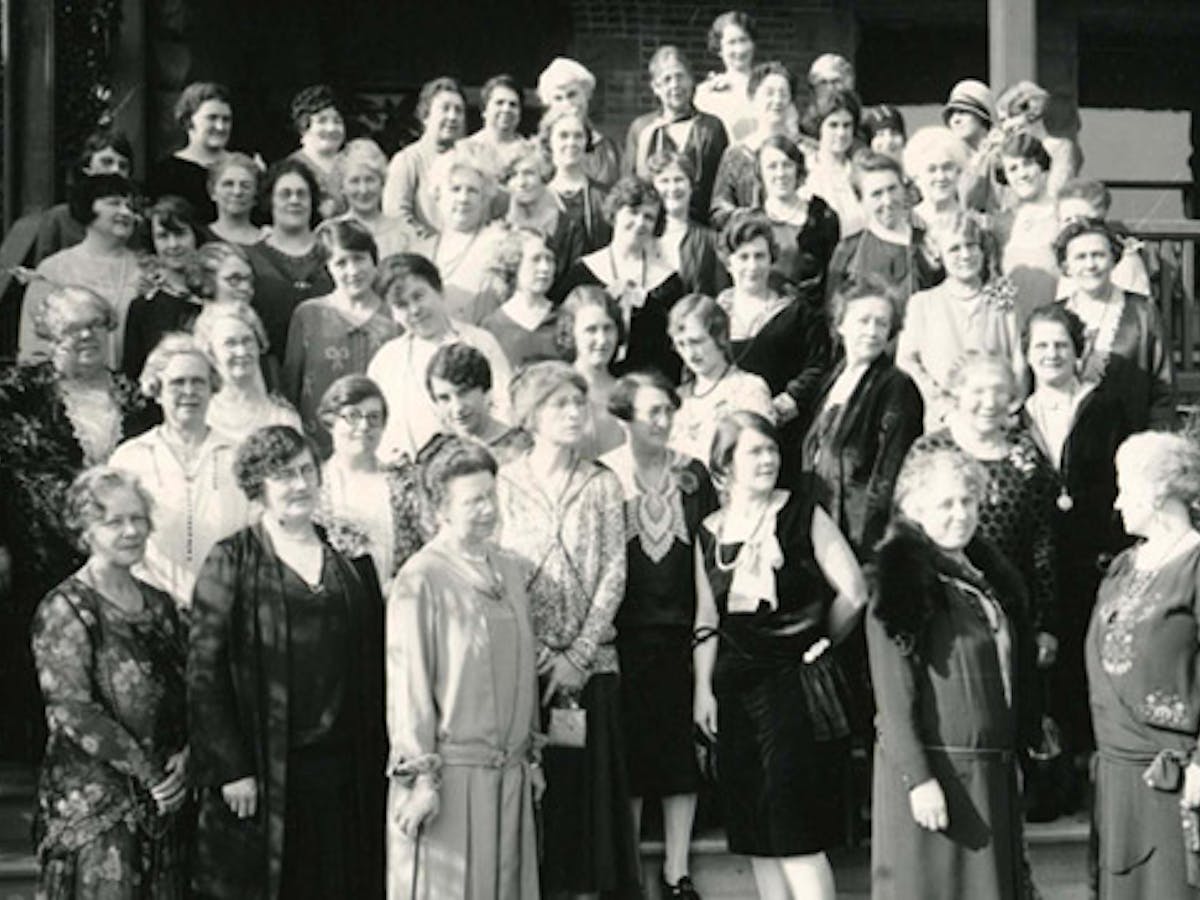 a group of people standing in front of a crowd posing for the camera
