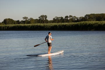 a man riding a board on a body of water