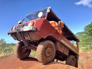 a truck driving down a dirt road