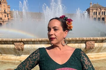 a person with a fountain in front of a body of water