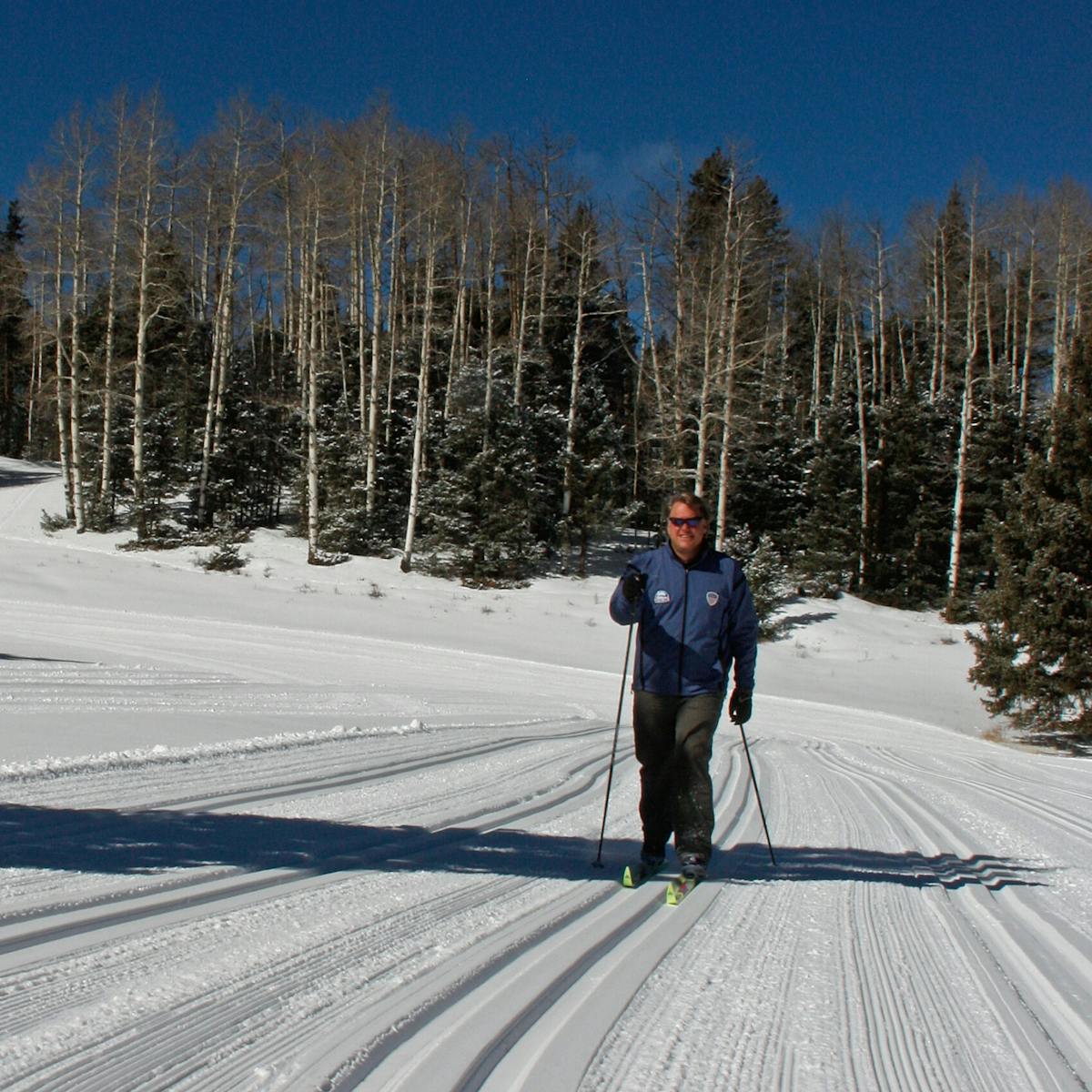 a man riding skis down a snow covered slope